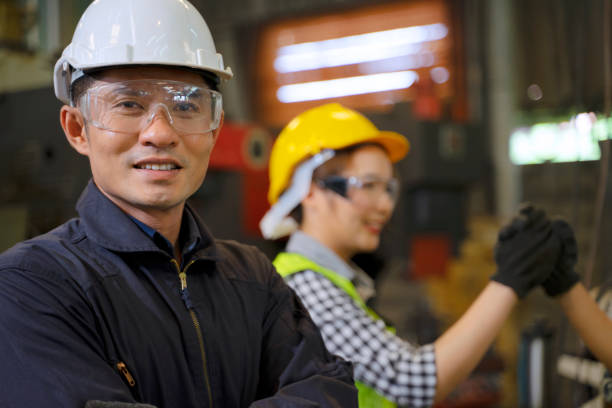 istock Blue collar worker works machine at factory. 1406896005