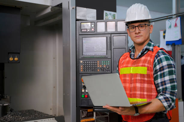 istock Blue collar worker works machine at factory. 1406896068