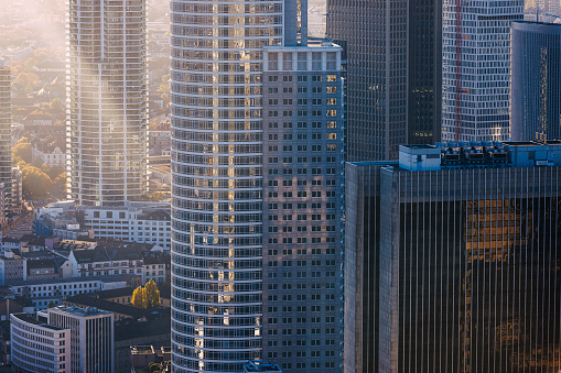 View on corporate buildings in glass and steel in financial district in Frankfurt am Main, illuminated with sunlight