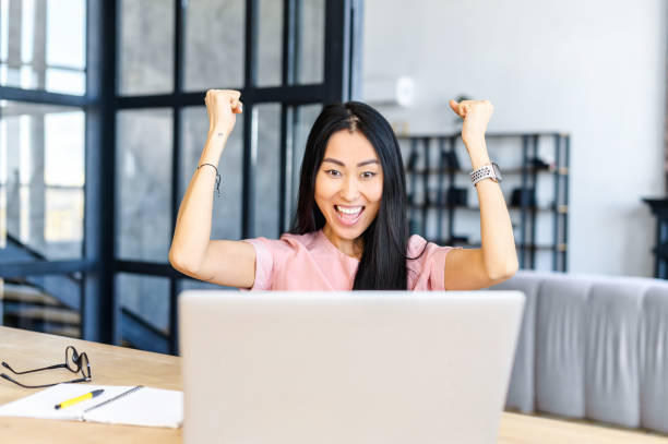 istock Happy female employee celebrating victory 1406897942