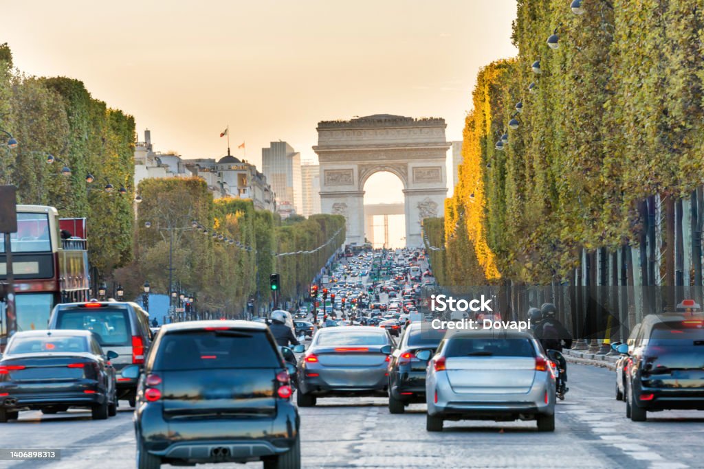 Avenue des Champs-Elysees and Arc de Triomph Sunset at Avenue des Champs-Elysees with car traffic and view to Arc de Triomphe. Paris, France Paris - France Stock Photo