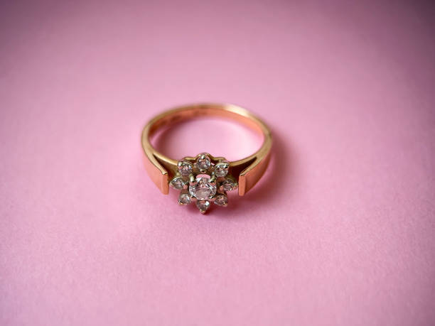 istock Gold diamond ring on pink isolated background. Red Gold Ring 1406898661