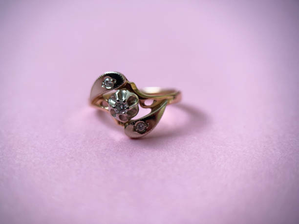 istock Gold diamond ring on pink isolated background. Red Gold Ring 1406898666