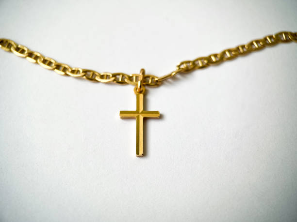 istock Gold cross on a gold chain close-up on a white isolated background 1406898681