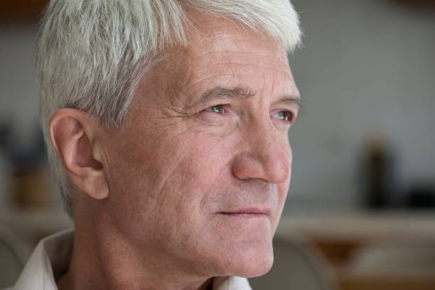 istock Closeup sad thoughtful silver haired elderly man pensioner look aside 1406899736