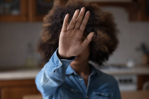 istock Afro American female stretch hand to camera show stop gesture 1406899784