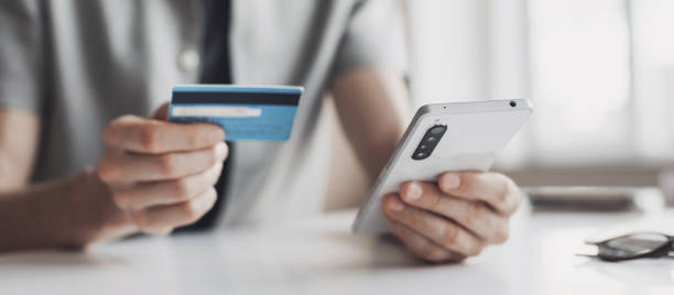 istock Man paiyng online using smartphone and credit card 1406899986