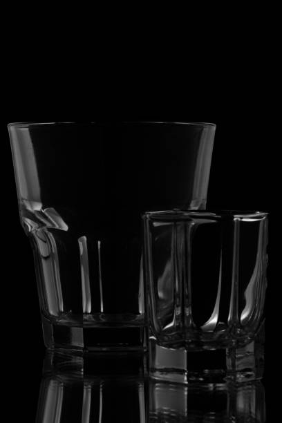 Glass and cup on a black background.