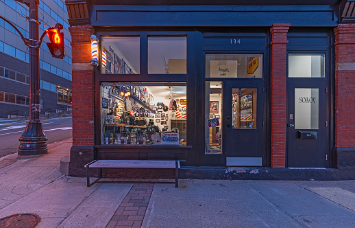 St. John’s, Newfoundland and Labrador, Canada – June 23, 2022:  Early morning exterior view of a downtown barber shop on Water Street