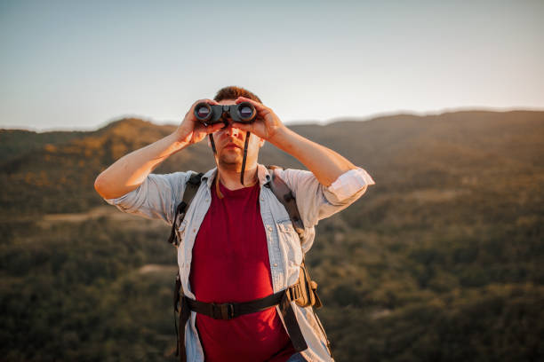 istock Male hiker bird watching and looking at the view from mountain 1406902597
