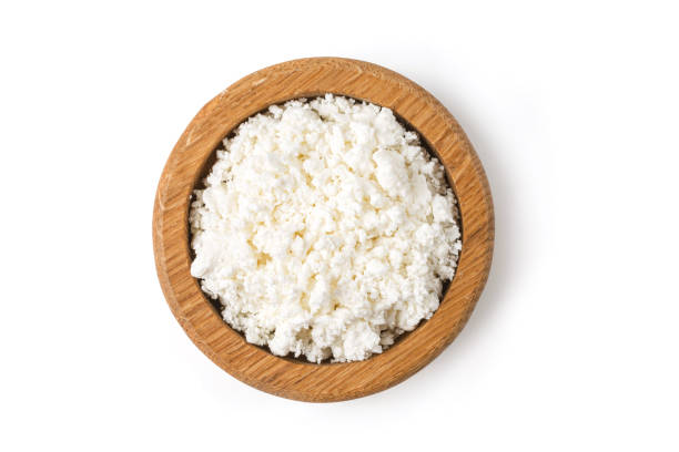 istock ottage cheese in wooden bowl on white background 1406903646