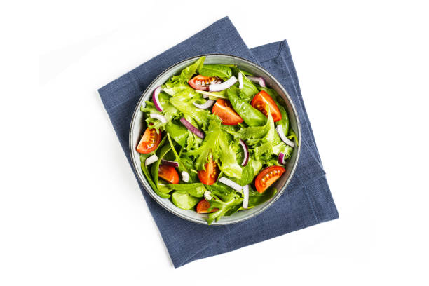 istock Summre green salad in white bowl plate on grey table 1406903648