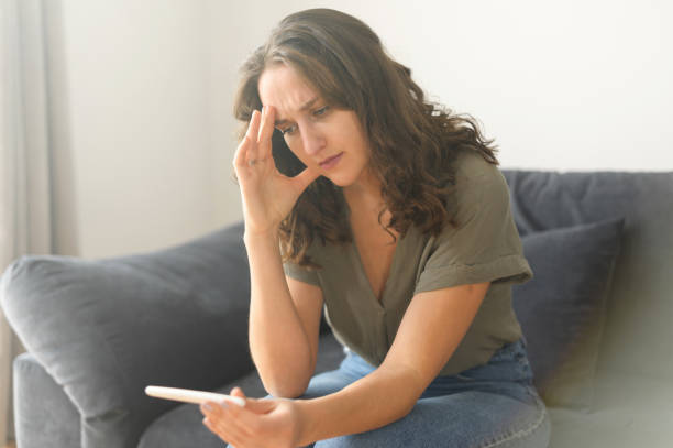 istock Attractive curly young woman holds pregnancy test stick 1406904712