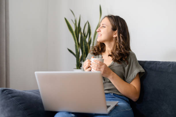 istock Attractive curly young woman drinks coffee 1406904785