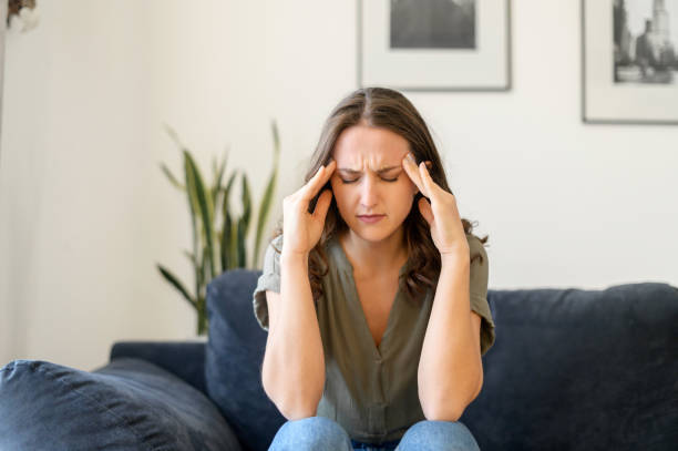 istock Attractive curly young woman suffering from headache 1406904796