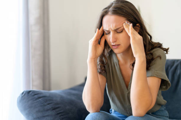 istock Attractive curly young woman suffering from headache 1406904799