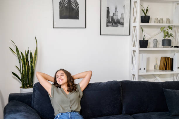 istock Woman at home, rests on couch at home, leaned back 1406904800