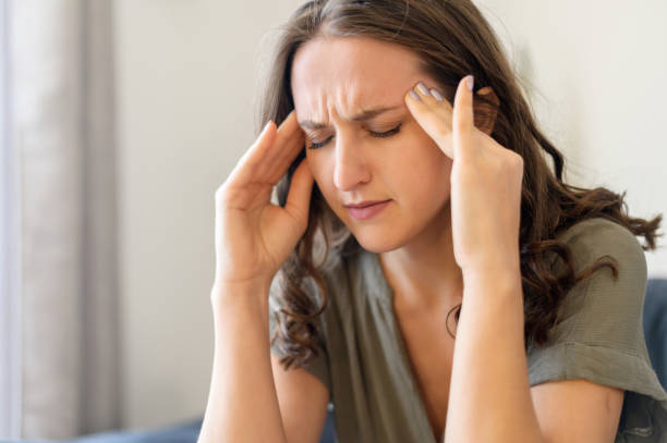 istock Attractive curly young woman suffering from headache 1406904801
