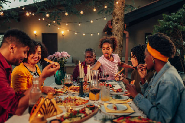 istock Family gathering over dinner in the yard 1406904809