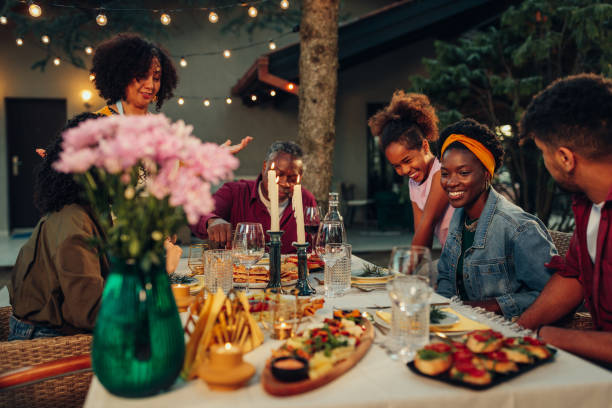 Family enjoying dinner during their get together in the backyard