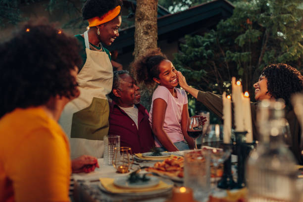 istock Family gathering over dinner in the yard 1406904935