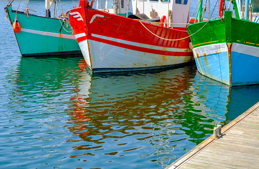 Colorful fishing boats in the port of Paimpol in Bretagne, France during summer.