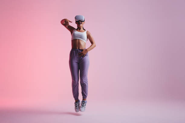 istock Energetic young woman dancing in virtual reality 1406905308