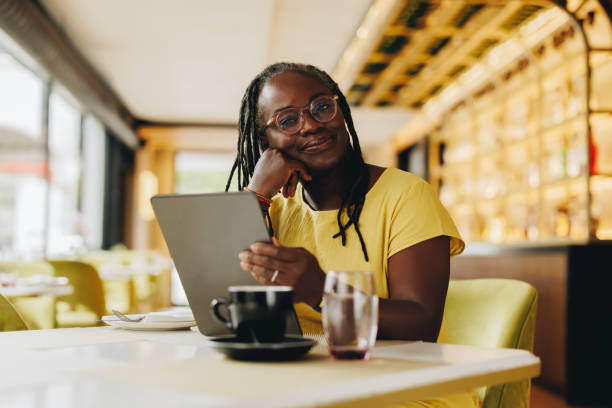 Mature woman working with a digital tablet in a cafe