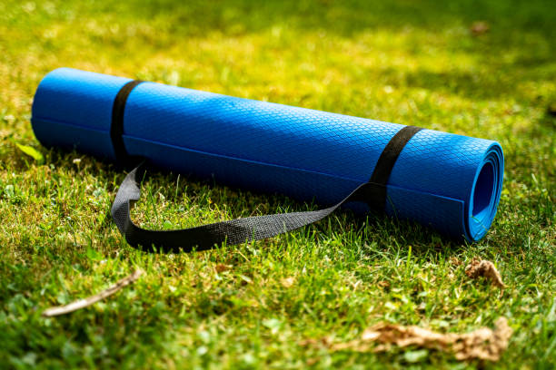 istock Blue exercise mat on fresh green grass outdoors, closeup stock photo 1406907719