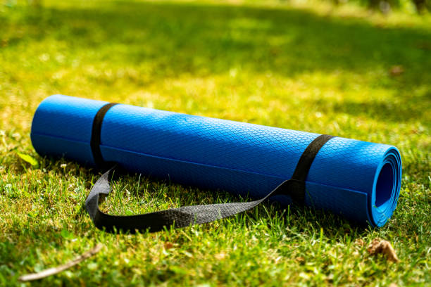 istock Blue exercise mat on fresh green grass outdoors, closeup stock photo 1406907722