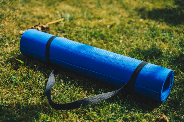 istock Blue exercise mat on fresh green grass outdoors, closeup stock photo 1406907724
