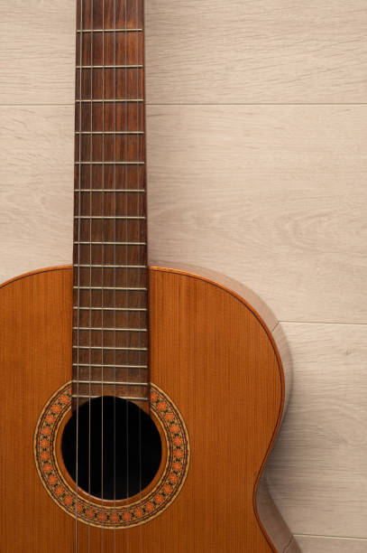 istock Classical guitar body, on a light wood background. 1406907998