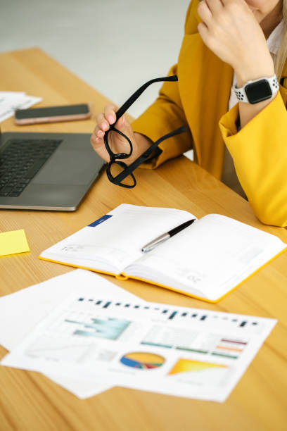 Woman planning working schedule writing in notebook close-up