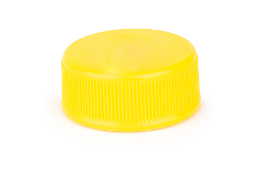 bottle cap plastic yellow isolated on white background.