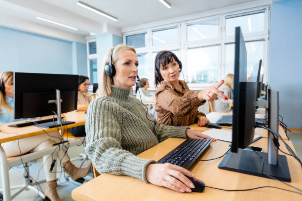Female manager training trainee over computer stock photo