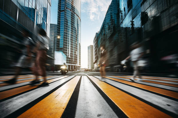 People walking across a crosswalk in modern downtown
