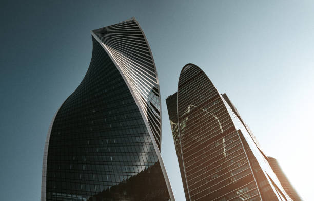 Modern skyscrapers against clear sky and glowing sun