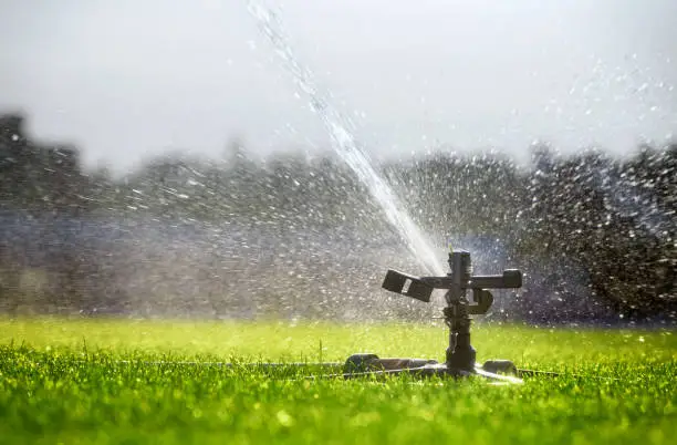 Automatic watering system sprays water on the lawn. Irrigation.