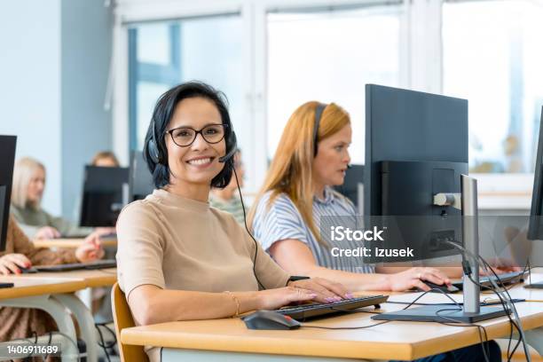 Smiling Manager By Female Colleague Stock Photo - Download Image Now - Day, Trainee, 40-44 Years