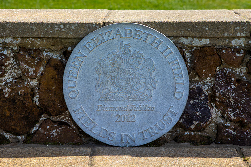 Norfolk, UK - April 8th 2022: Close-up of a plaque on the Green, also known as the Queen Elizabeth II Field in the beautiful seaside town of Hunstanton in Norfolk, UK.