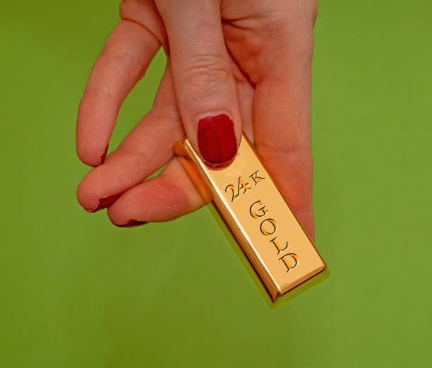 Female hand with  gold bar stock photo