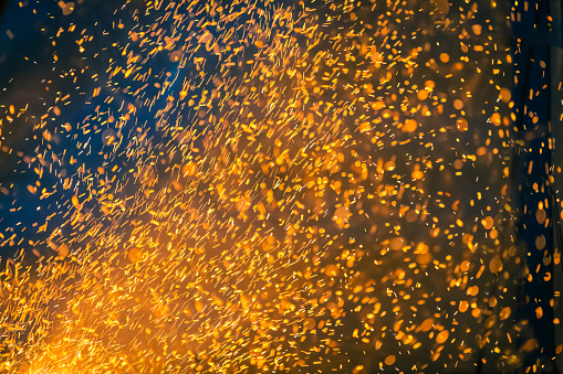 Flame and fire spark with bokeh on dark abstract background