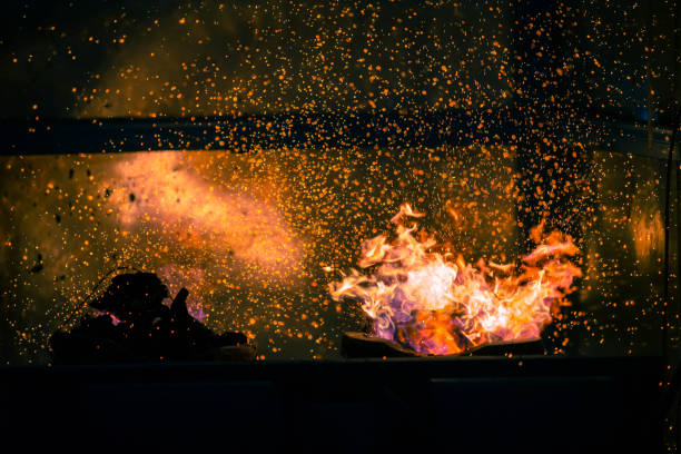 istock Flame and fire spark with bokeh  from burning charcoal on dark abstract background 1406913596