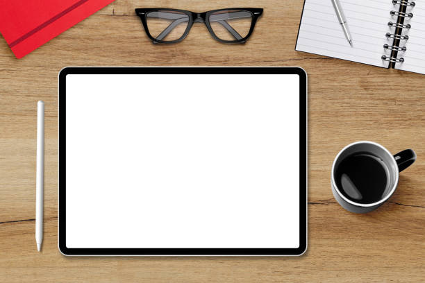 istock Digital tablet pc with empty white screen and wireless pen on office desk 1406913692