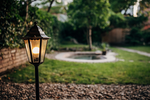 Lamp post in beautiful back yard.