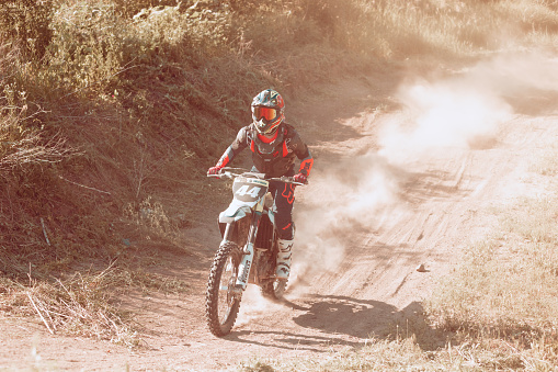 Dnipro, Ukraine JUNE 11, 2022. Ukrainian professional motorcycle rider driving on Enduro motorcycle, outdoors at hot summer day. Motocross sport training