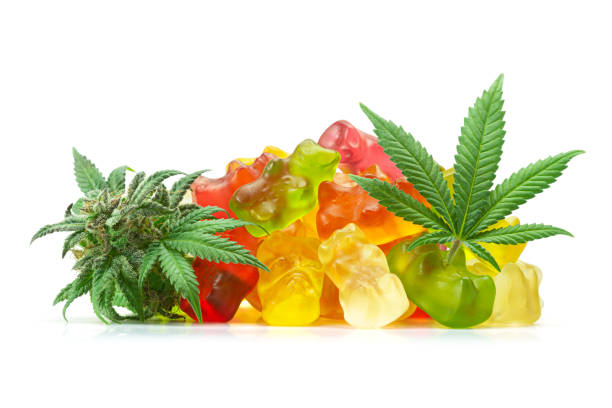 Medical Cannabis Infused Fruit Flavored CBD Gummy Bears with Marijuana Leaf and Hemp Bud Isolated on White Background A pile of medical cannabis infused CBD or THC gummy bears in assorted fruit flavors with a marijuana leaf and hemp bud isolated on a white background. cannabis gummy bears stock pictures, royalty-free photos & images