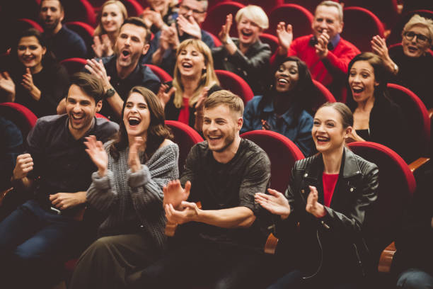 Happy audience applauding in the theater Group of excited people clapping hands in the theater. stage theater stock pictures, royalty-free photos & images