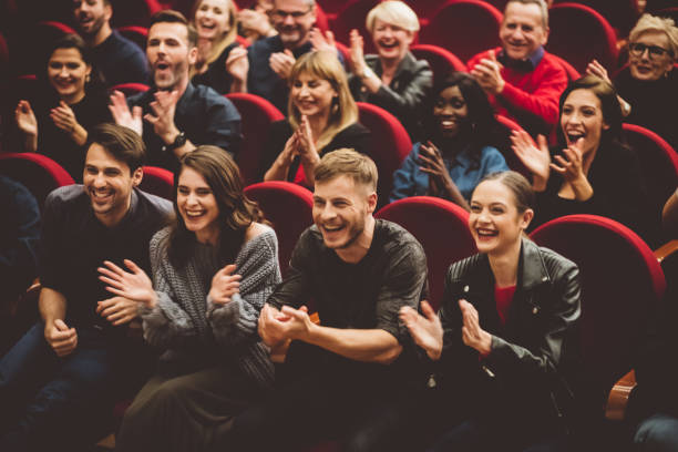 Happy audience applauding in the theater stock photo