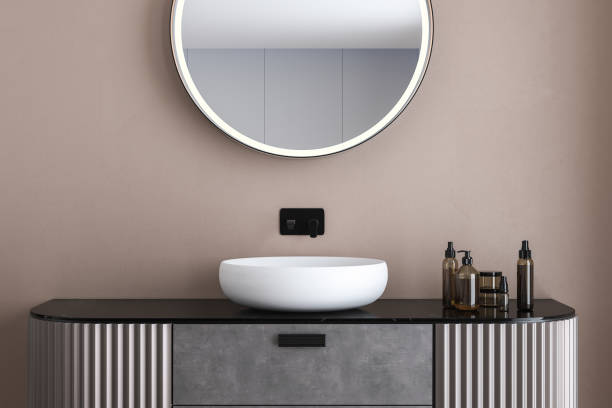 istock Comfortable white sink with oval mirror standing on marble countertop 1406918757